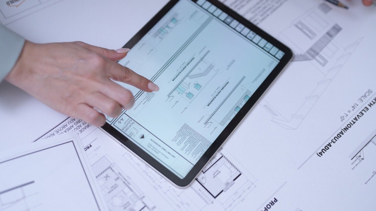 Fast Build team verifying as-built dimensions on a tablet