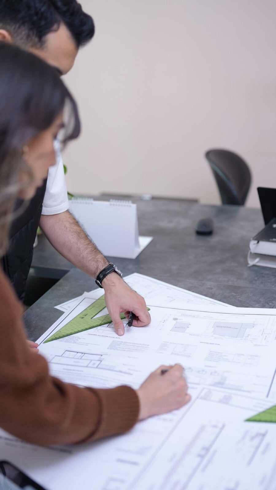 Fast Build engineer reviewing a permit drawing set in the office